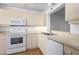 Cozy kitchen with white appliances and lots of cabinet space at 4570 Pinebrook Cir # 406, Bradenton, FL 34209