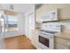 Bright kitchen featuring modern appliances and ample storage space with a view at 4570 Pinebrook Cir # 406, Bradenton, FL 34209