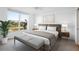 Light filled main bedroom featuring a golf course view, neutral colors and bench at 4570 Pinebrook Cir # 406, Bradenton, FL 34209