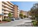 Condo building exterior showcasing convenient parking spaces and well-maintained landscaping at 4570 Pinebrook Cir # 406, Bradenton, FL 34209