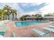 Relaxing community pool area with lounge chairs, umbrellas, and a nearby clubhouse at 4570 Pinebrook Cir # 406, Bradenton, FL 34209