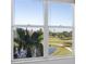 Scenic view of a pond and golf course through a window at 4570 Pinebrook Cir # 406, Bradenton, FL 34209
