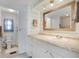 Bathroom with white cabinets, granite countertops, and modern fixtures at 520 Ideal Pl, North Port, FL 34287