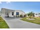 Charming single-story home with a covered carport, manicured lawn, and well-maintained landscaping at 520 Ideal Pl, North Port, FL 34287