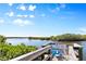 Picturesque fishing pier overlooking serene waters, with lush greenery and blue skies at 520 Ideal Pl, North Port, FL 34287