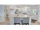 Updated kitchen with white cabinetry, modern appliances, and a breakfast bar, ideal for casual dining and entertaining at 520 Ideal Pl, North Port, FL 34287