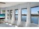 Bright living room with large windows overlooking a waterfront view and sheer white curtains at 520 Ideal Pl, North Port, FL 34287