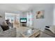 Comfortable seating in a spacious living room with a large TV and relaxing view of an adjacent sitting area at 520 Ideal Pl, North Port, FL 34287