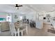 Open concept living space combining a dining area, living room, and kitchen with white cabinetry at 520 Ideal Pl, North Port, FL 34287
