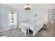 Cozy main bedroom featuring light blue walls, and a window with sheer white curtains at 520 Ideal Pl, North Port, FL 34287