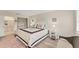 Comfortable bedroom featuring a star themed comforter, soft lighting, and access to an ensuite bathroom at 5264 Lake Village Dr # 48, Sarasota, FL 34235