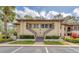 Exterior view of a multi-Gathering home with well-kept landscaping, stairs, and tile roof at 5264 Lake Village Dr # 48, Sarasota, FL 34235
