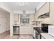 Functional kitchen with stainless steel dishwasher and view to the living area at 5264 Lake Village Dr # 48, Sarasota, FL 34235