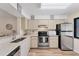 Kitchen featuring stainless steel appliances, light cabinets, and a breakfast bar at 5264 Lake Village Dr # 48, Sarasota, FL 34235