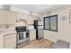 Bright kitchen featuring stainless steel appliances and a window at 5264 Lake Village Dr # 48, Sarasota, FL 34235