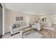 Cozy living room featuring comfortable seating and view into dining area at 5264 Lake Village Dr # 48, Sarasota, FL 34235