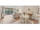Inviting living room area featuring neutral tones, wood floors and a view to the outside patio at 5264 Lake Village Dr # 48, Sarasota, FL 34235