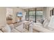 Inviting living room with access to a balcony and view to the bedroom at 5264 Lake Village Dr # 48, Sarasota, FL 34235