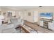 Comfortable living room with wood flooring and a view of the kitchen and dining area at 5264 Lake Village Dr # 48, Sarasota, FL 34235