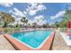 Community pool view featuring a clear pool, furniture and a white fence at 5264 Lake Village Dr # 48, Sarasota, FL 34235