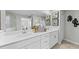 Bright bathroom boasts double sinks, white cabinetry, and a well-lit mirror at 5616 Summit Pointe Cir # 101, Bradenton, FL 34210