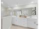 Bright bathroom with double sinks, tiled floor, and a glass shower at 5616 Summit Pointe Cir # 101, Bradenton, FL 34210