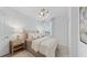 Bright bedroom features neutral decor, a decorative light fixture, and a window providing natural light at 5616 Summit Pointe Cir # 101, Bradenton, FL 34210