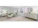 Spacious main bedroom with bright white and green accents, tile floors, and contemporary furniture at 5616 Summit Pointe Cir # 101, Bradenton, FL 34210