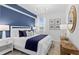 Cozy bedroom with a blue accent wall, comfortable bed, and tasteful decor creating a relaxing retreat at 5616 Summit Pointe Cir # 101, Bradenton, FL 34210