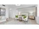 Bright main bedroom with calming light-green and white accents, tile floor, and decorative wall art at 5616 Summit Pointe Cir # 101, Bradenton, FL 34210