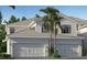 Charming two-story home featuring a spacious two-car garage, palm trees, and well-maintained landscaping at 5616 Summit Pointe Cir # 101, Bradenton, FL 34210