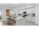 Beautiful kitchen with an island, bar seating, white cabinets, and views of the outdoors through the window at 5616 Summit Pointe Cir # 101, Bradenton, FL 34210