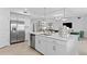 Modern kitchen with stainless steel appliances, a large center island, and sleek white cabinetry at 5616 Summit Pointe Cir # 101, Bradenton, FL 34210