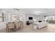 Open-concept living room and dining area featuring modern decor, light walls and tiled floors at 5616 Summit Pointe Cir # 101, Bradenton, FL 34210