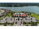 An aerial view of the community pool and amenities with a large lake in the background at 5811 Campina Pl, Palmetto, FL 34221