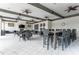 Open clubhouse seating area with beams, ceiling fans and a fireplace with TV above at 5811 Campina Pl, Palmetto, FL 34221
