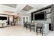 Modern clubhouse area with a bar, television, seating, and stylish decor at 5811 Campina Pl, Palmetto, FL 34221
