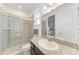 Modern bathroom with a glass-enclosed shower and a granite vanity at 5811 Campina Pl, Palmetto, FL 34221