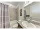 Bathroom with granite countertops, shower-tub combo, and decorative mirror at 5811 Campina Pl, Palmetto, FL 34221