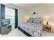 Well-lit bedroom with decorative bedding, TV, and view from the window at 5811 Campina Pl, Palmetto, FL 34221