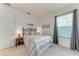 Comfortable bedroom featuring a wrought iron headboard, soft carpet, and bright natural lighting at 5811 Campina Pl, Palmetto, FL 34221