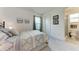 Well-lit bedroom adjacent to an ensuite bathroom with a modern design at 5811 Campina Pl, Palmetto, FL 34221