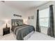 Cozy bedroom featuring carpet floors, a queen bed, and a window at 5811 Campina Pl, Palmetto, FL 34221