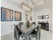 Dining room with dark wood table and geometric pendant lighting fixture at 5811 Campina Pl, Palmetto, FL 34221