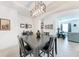 Dining room with dark wood table and geometric pendant lighting fixture at 5811 Campina Pl, Palmetto, FL 34221