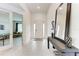 Open entryway with a mirror console table and tile flooring, flowing into the living spaces at 5811 Campina Pl, Palmetto, FL 34221