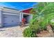 Inviting home entrance with well-kept landscaping and a brick paver walkway leading to the front door at 5811 Campina Pl, Palmetto, FL 34221