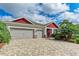 Charming exterior featuring a brick paver driveway and a three-car garage at 5811 Campina Pl, Palmetto, FL 34221