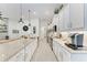Bright, white kitchen with stone countertops and stainless steel appliances at 5811 Campina Pl, Palmetto, FL 34221