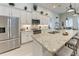 Bright, white kitchen with stone countertops and stainless steel appliances at 5811 Campina Pl, Palmetto, FL 34221